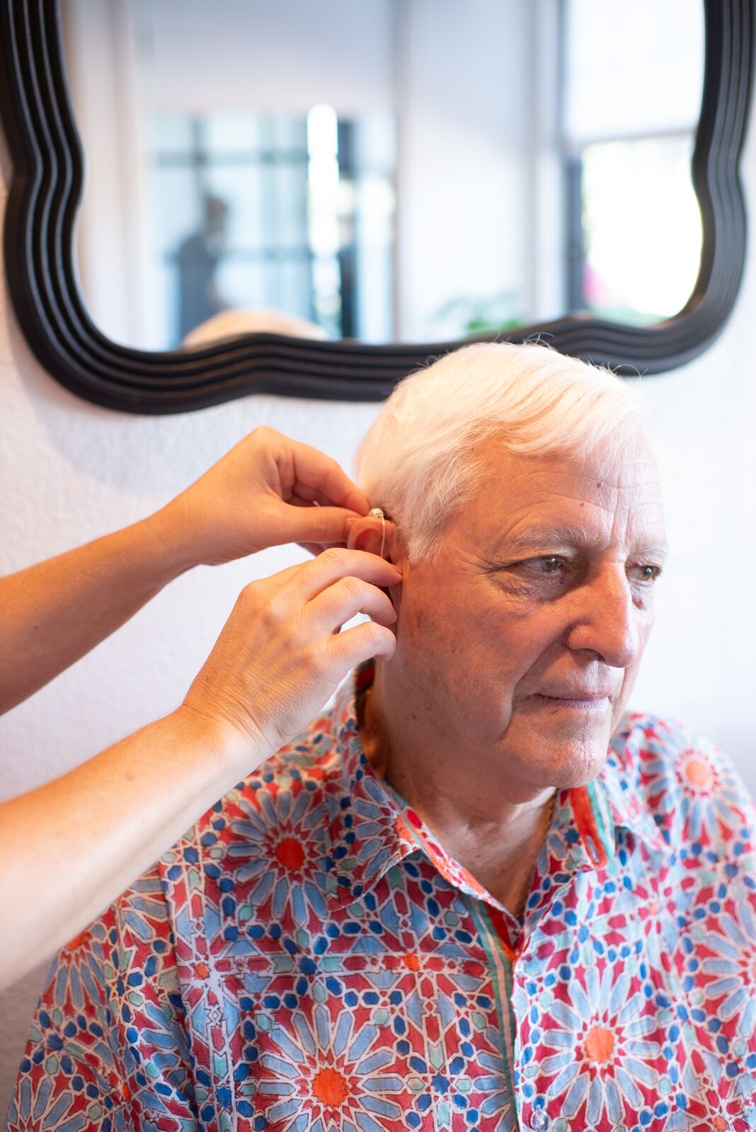 Audiologist with a patient during a fitting